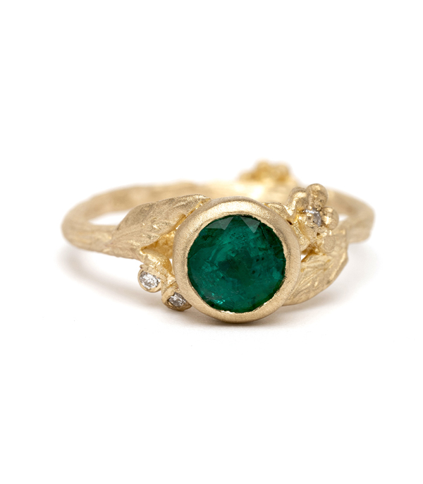 Dainty, feminine, and utterly charming! Our emerald solitaire features a 14K yellow gold twiggy textured band, diamond accented daisies and pods, and one stunning natural emerald Round Brilliant Cut center stone (approx 1ct). Crafted by our artisan jewelers in Los Angeles. designed by Sofia Kaman handmade in Los Angeles using our SKFJ ethical jewelry process.