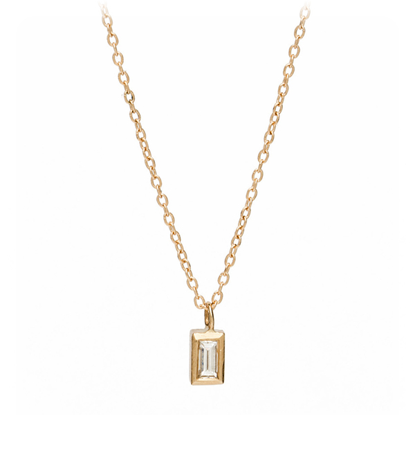 Chic and minimal, this baguette diamond necklace is your new, go-to, everyday jewel. Beautiful layered or worn on its own, a single diamond baguette (0.16ct) set in a golden bezel hangs vertically and slides smoothly on a dainty cable chain, and catches light at every move. Day to night, this tiny treasure will add a sparkle to your life!Crafted by our artisan jewelers in Los Angeles. designed by Sofia Kaman handmade in Los Angeles using our SKFJ ethical jewelry process.