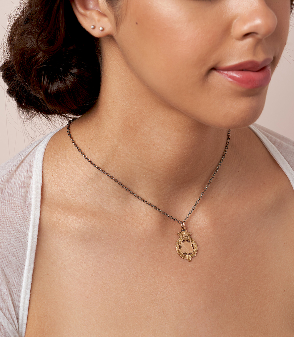 Antique gold flower shaped hint of peach pendant necklace